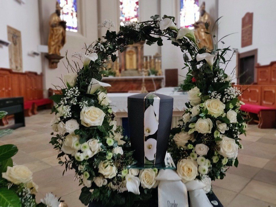 Floral wreath with white roses around a church altar in a cathedral nave
