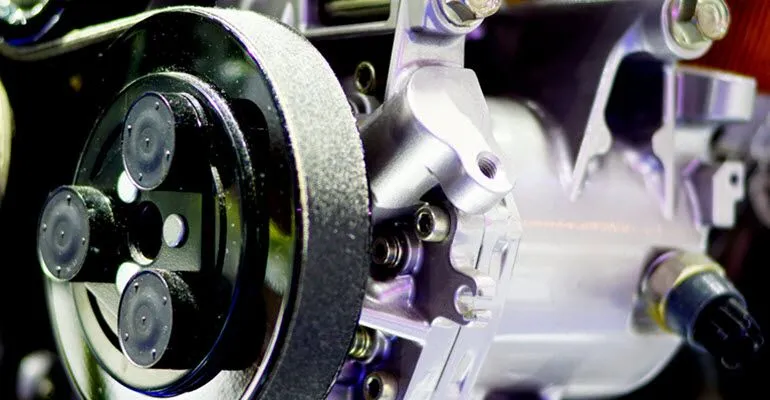A close up of a steering wheel on a car engine.