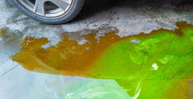 coolant leak under car green orange fluid puddle residue