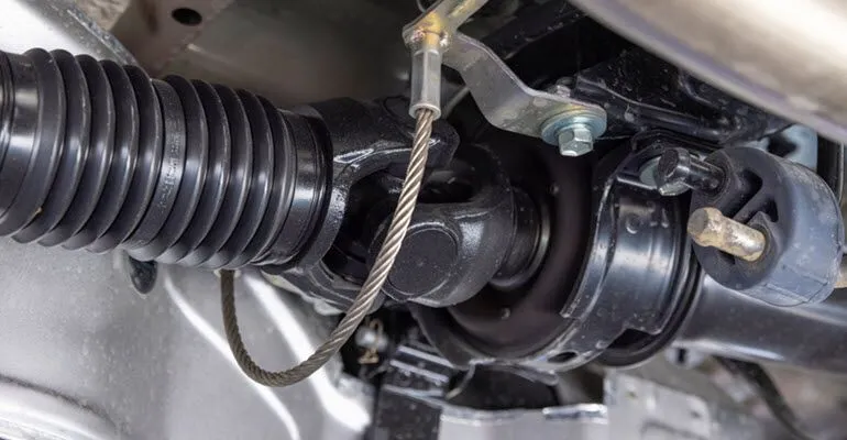 A close up of a steering gear on a car with a hose attached to it | Autohaus Service & Sales