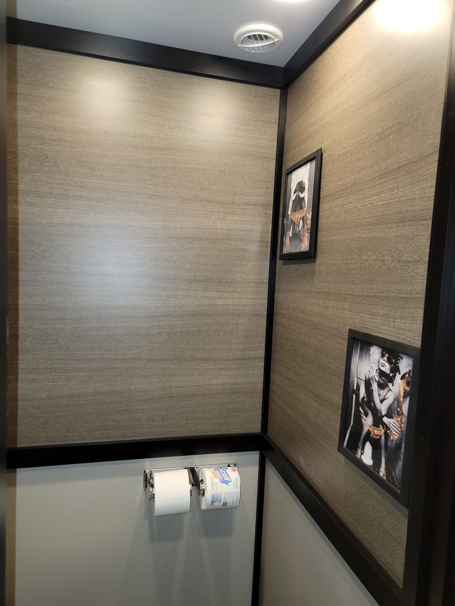 A bathroom with a picture of a football player on the wall