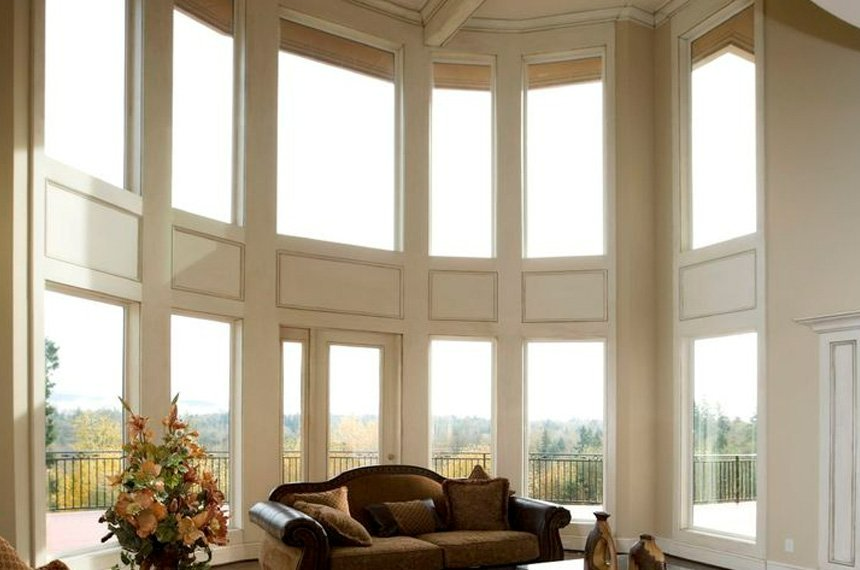 A living room with a couch and lots of windows