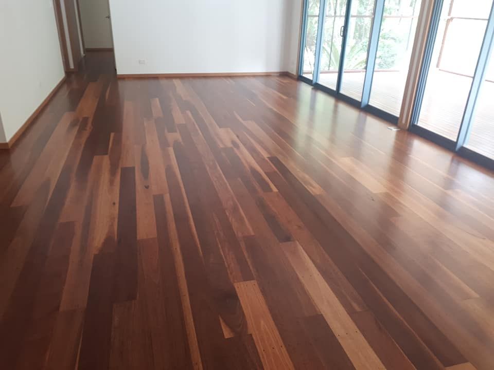 A Living Room with Hardwood Floors and Sliding Glass Doors — Finish It Floor Sanding in Bucca, QLD