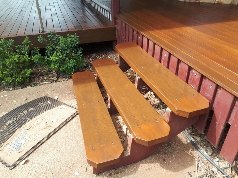 A Wooden Staircase with A Welcome Mat on The Ground — Finish It Floor Sanding in Bucca, QLD