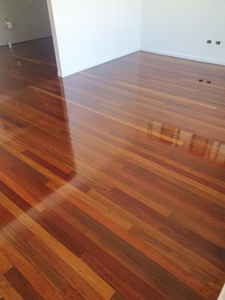 A Room with A Wooden Floor and A White Wall — Finish It Floor Sanding in Bucca, QLD