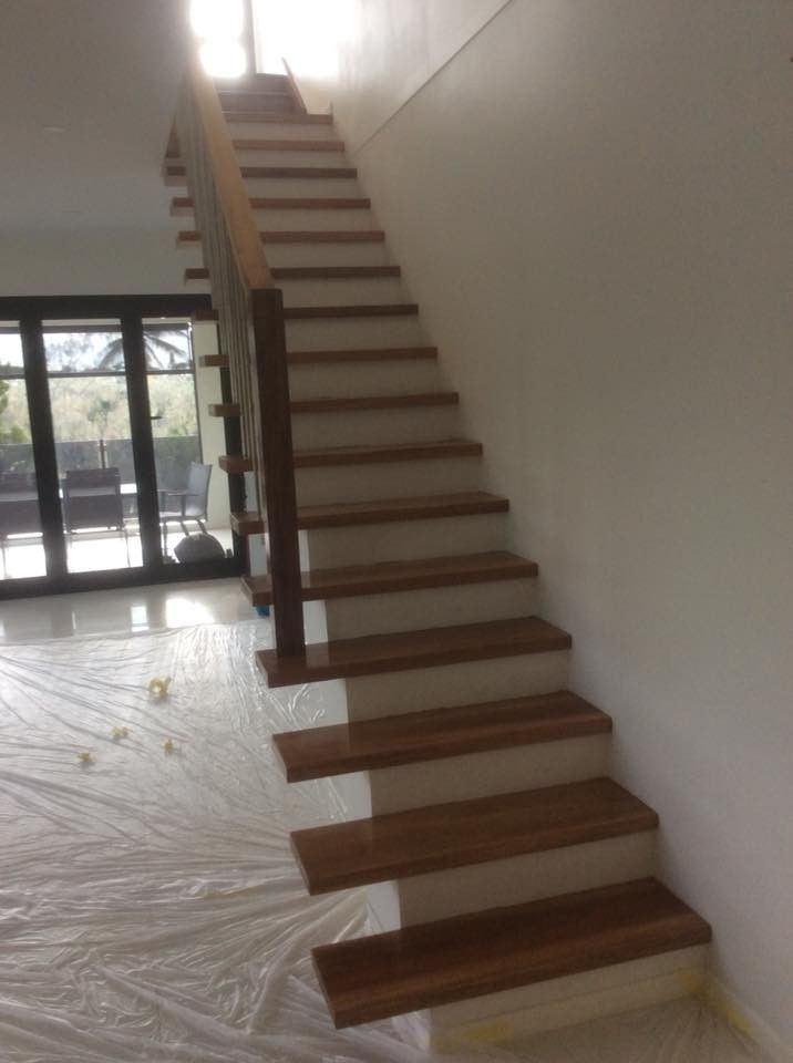 A Wooden Staircase in A Room with White Walls — Finish It Floor Sanding in Bucca, QLD
