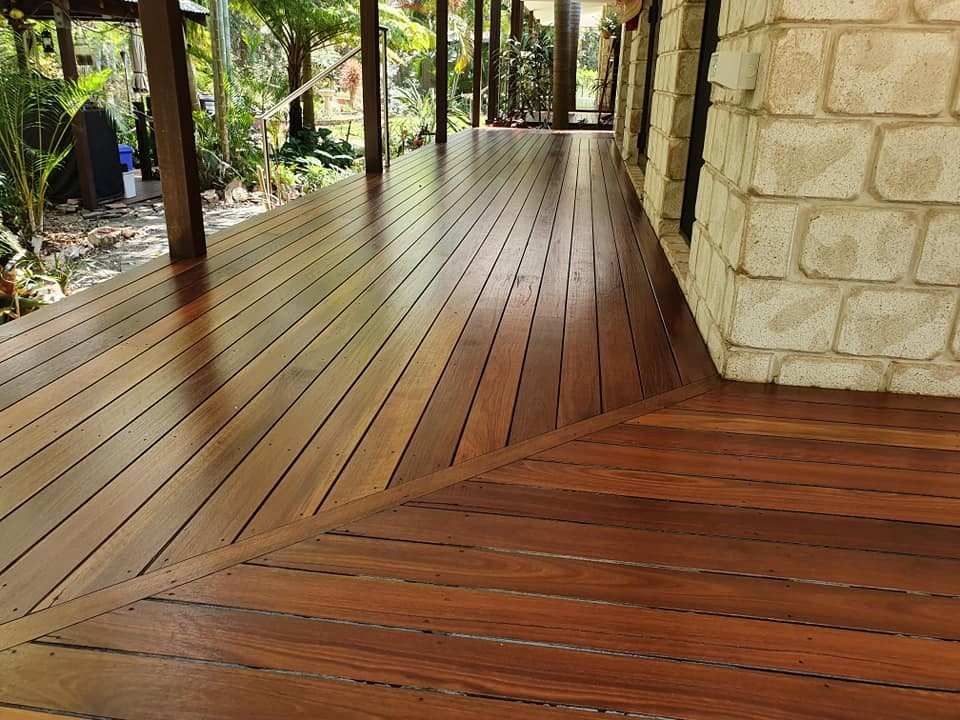 A Wooden Deck with A Brick Wall in The Background — Finish It Floor Sanding in Gayndah, QLD