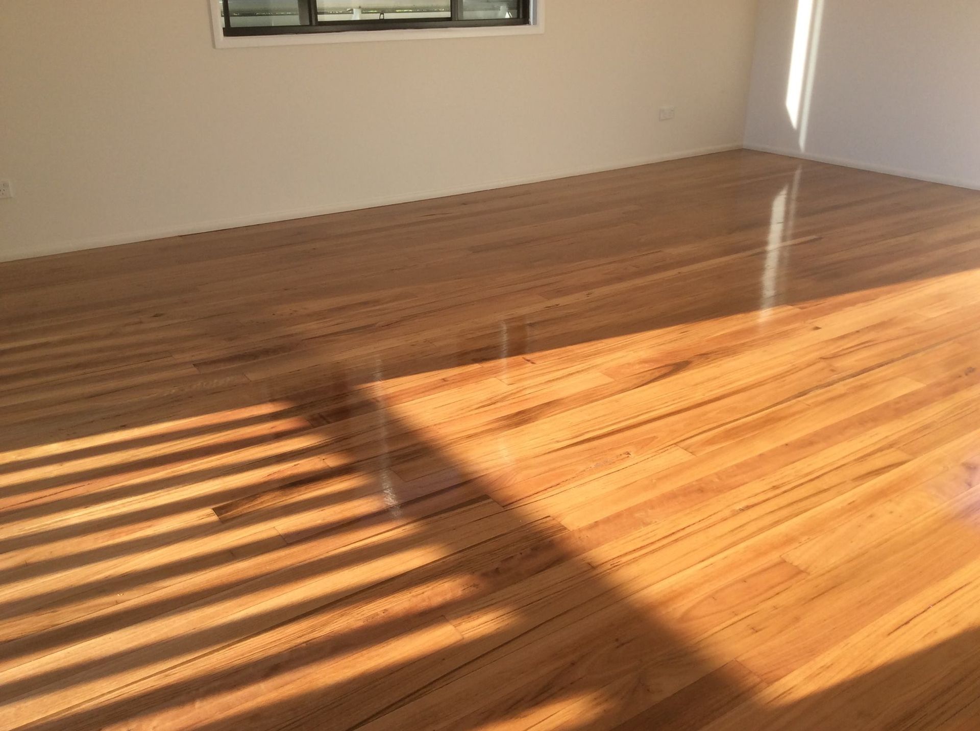 A Room with A Wooden Floor and A Window — Finish It Floor Sanding in Mundubbera, QLD