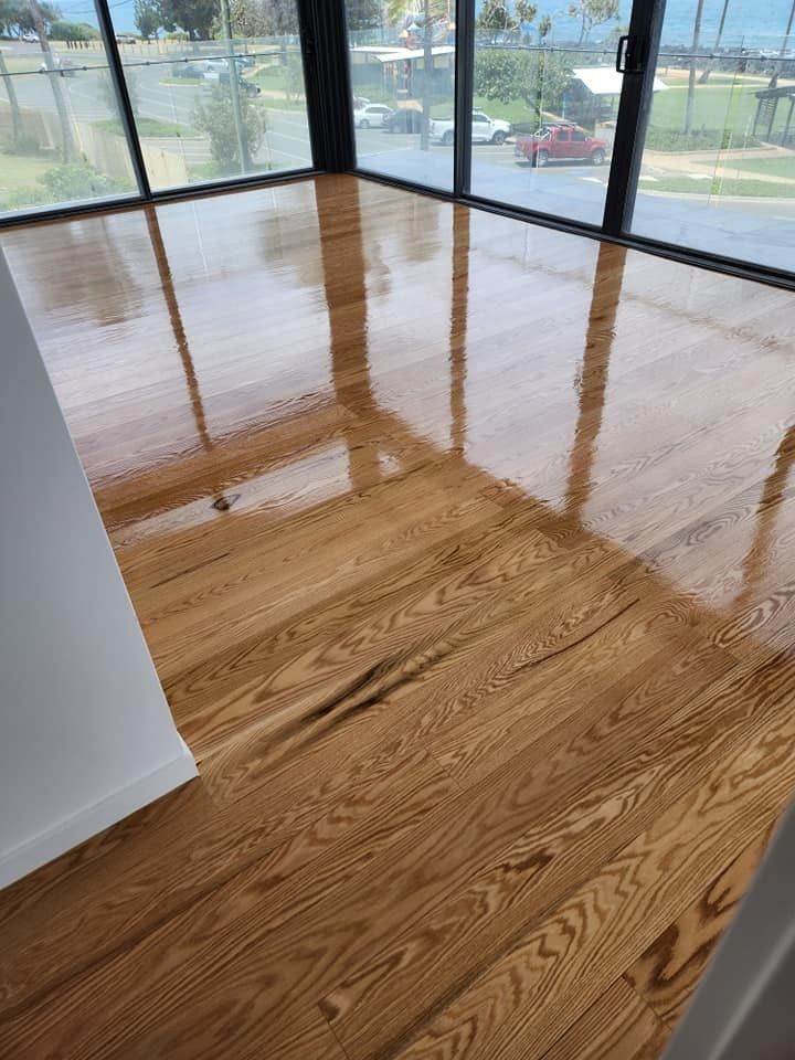 A Room with A Wooden Floor and A Lot of Windows — Finish It Floor Sanding in Bucca, QLD