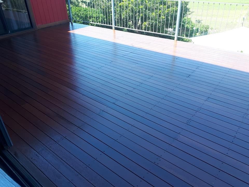 A Wooden Deck with A Railing and A View of A Field — Finish It Floor Sanding in Bucca, QLD