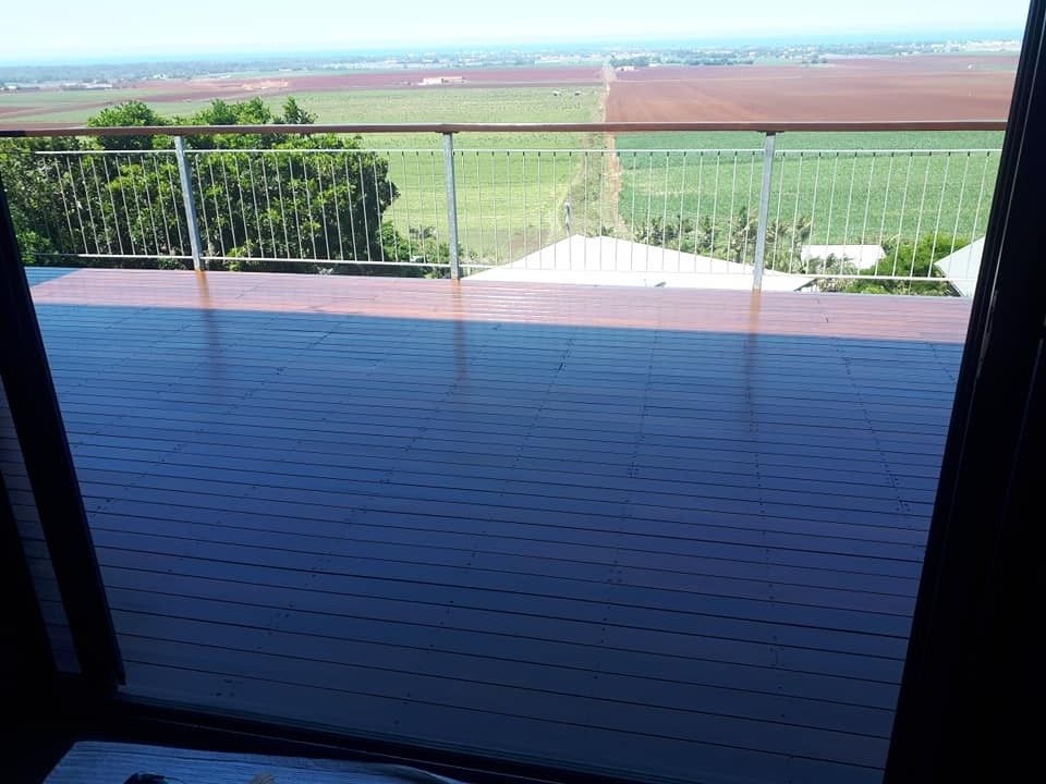 A Balcony with A View of A Field and Trees — Finish It Floor Sanding in Bucca, QLD