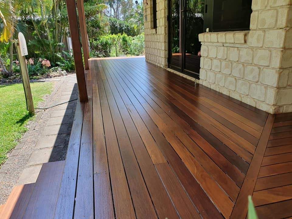 A Wooden Deck Is Sitting in Front of A Brick Building — Finish It Floor Sanding in Gayndah, QLD