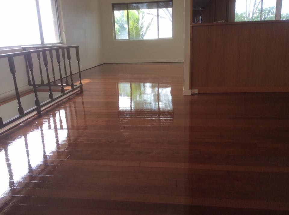 A Living Room with A Wooden Floor and A Balcony — Finish It Floor Sanding in Bucca, QLD
