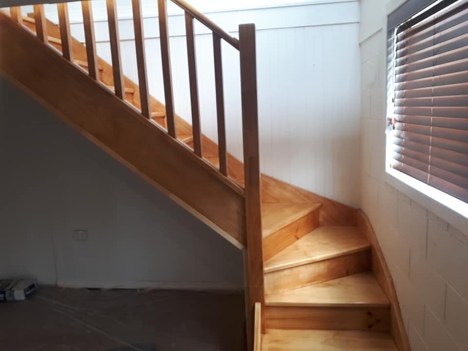 A Wooden Staircase Leading up To a Window with Blinds — Finish It Floor Sanding in Mundubbera, QLD