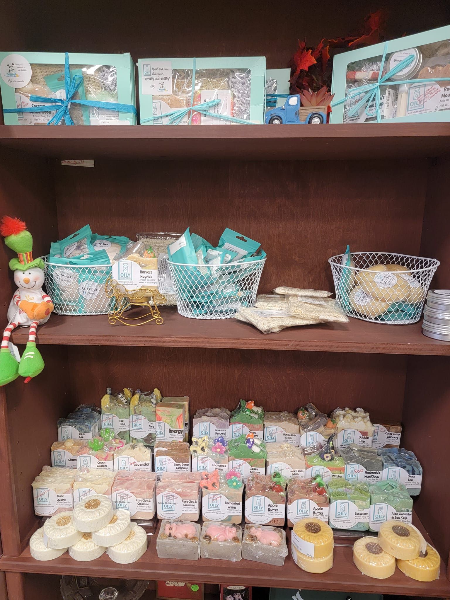 A shelf filled with lots of soaps and cookies.