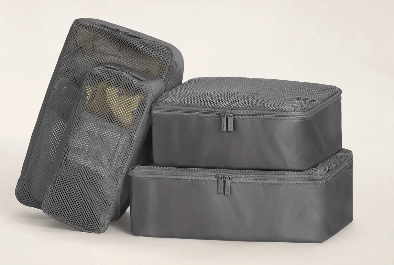 away insider packing cubes four packing cubes mesh tops asphalt color stacked and packed with travel items