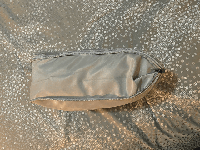 monos gray packing cube gray zippers side view compression zipper not fully zipped on gray bedspread