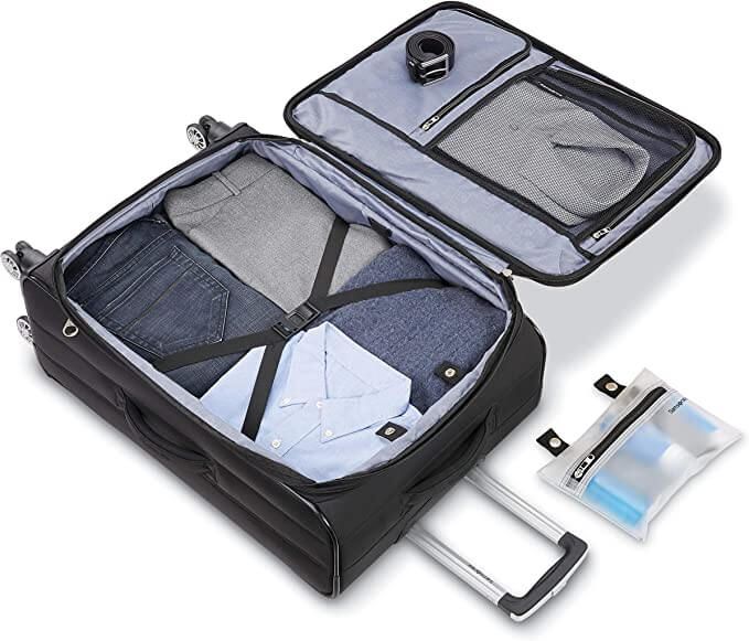 samsonite ascella x softside checked luggage black suitcase open interior one compartment with clothes and compression straps grey zippered compartments on interior of flap clear and black toiletries bag