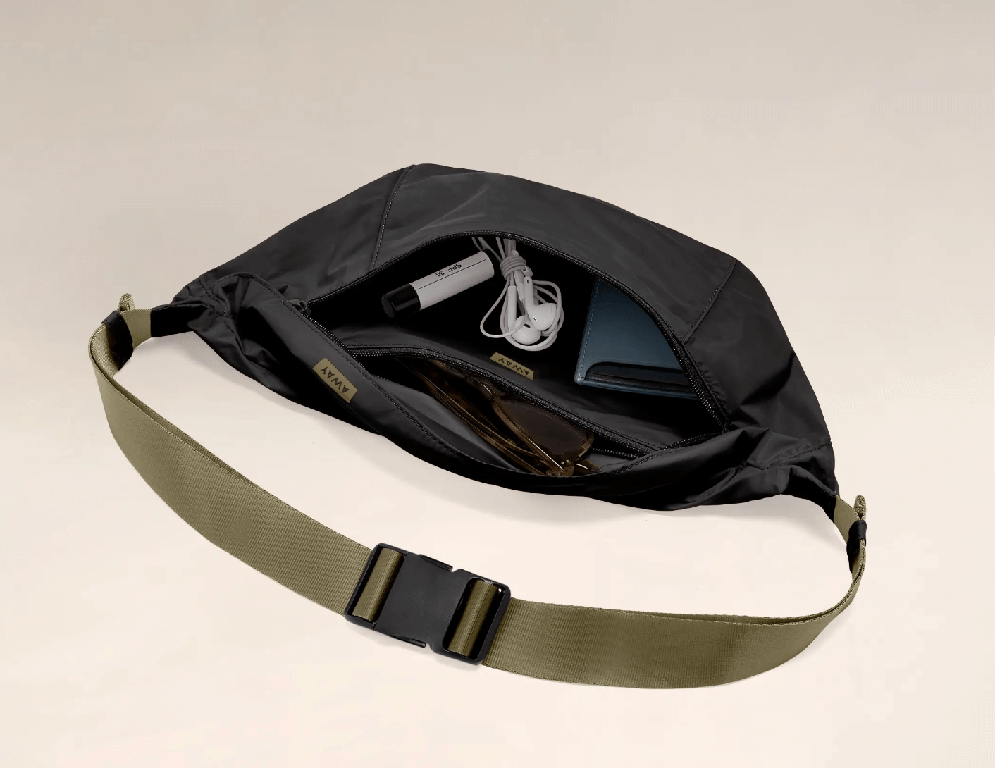 Away packable sling bag black nylon bag open zipper with wallet white headphones army green carrying strap