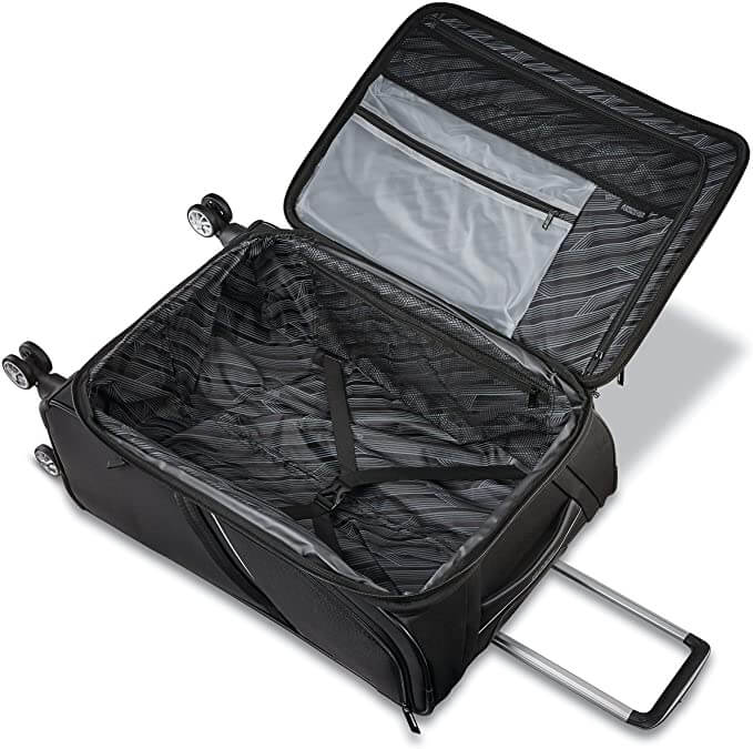 american tourister checked luggage black suitcase open on ground zippered compartments black compression straps grey interior design