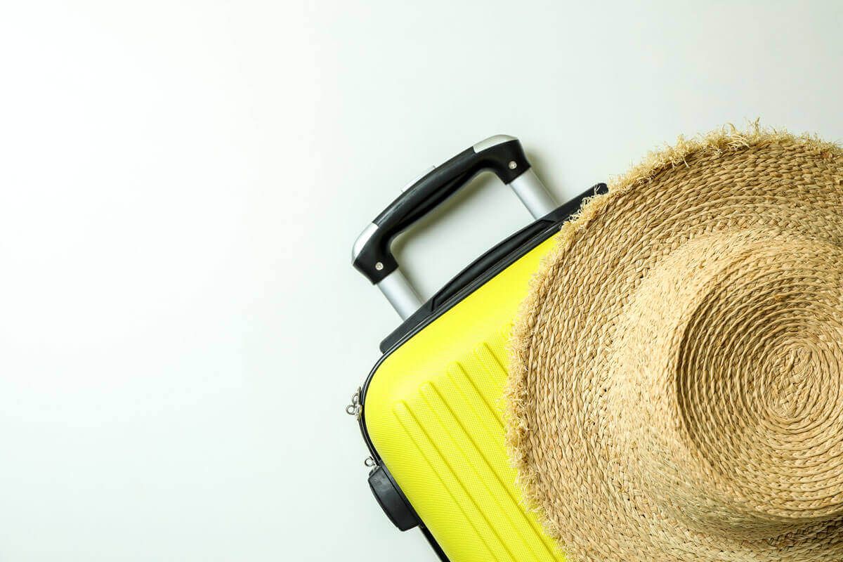 yellow suitcase straw beach hat