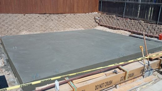 A large concrete slab is being built on a construction site.