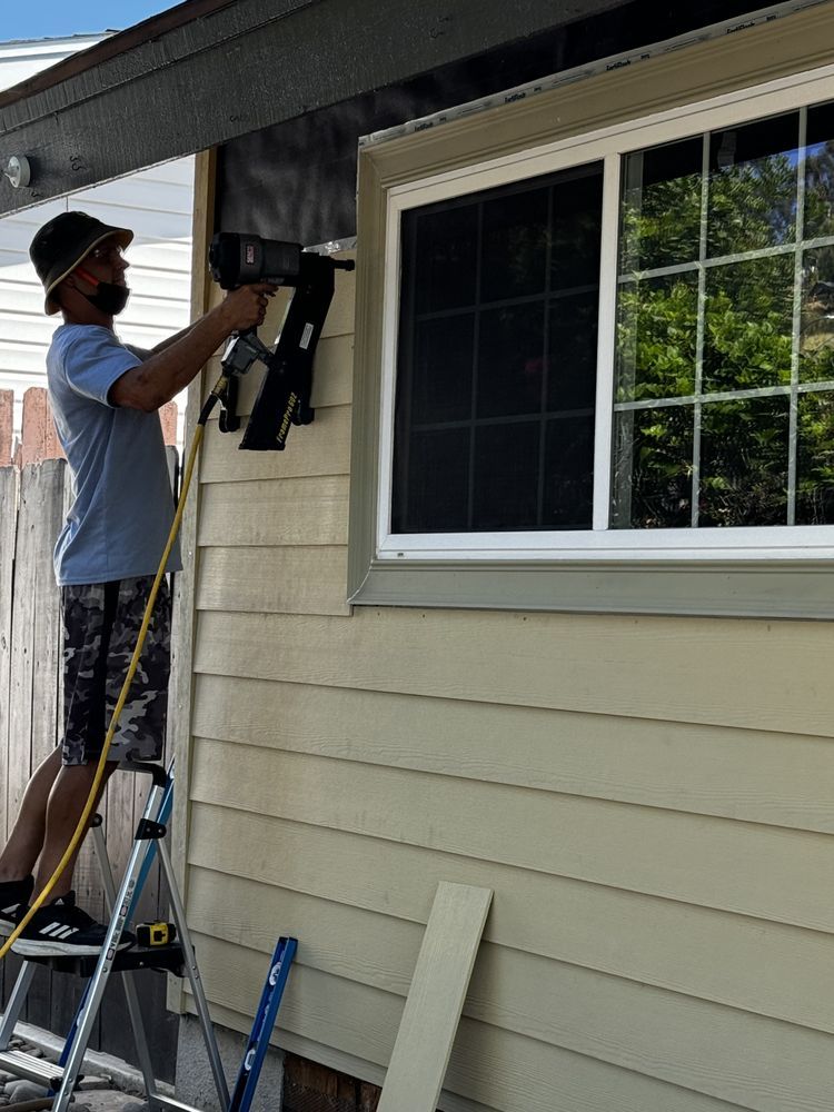 man fixing siding