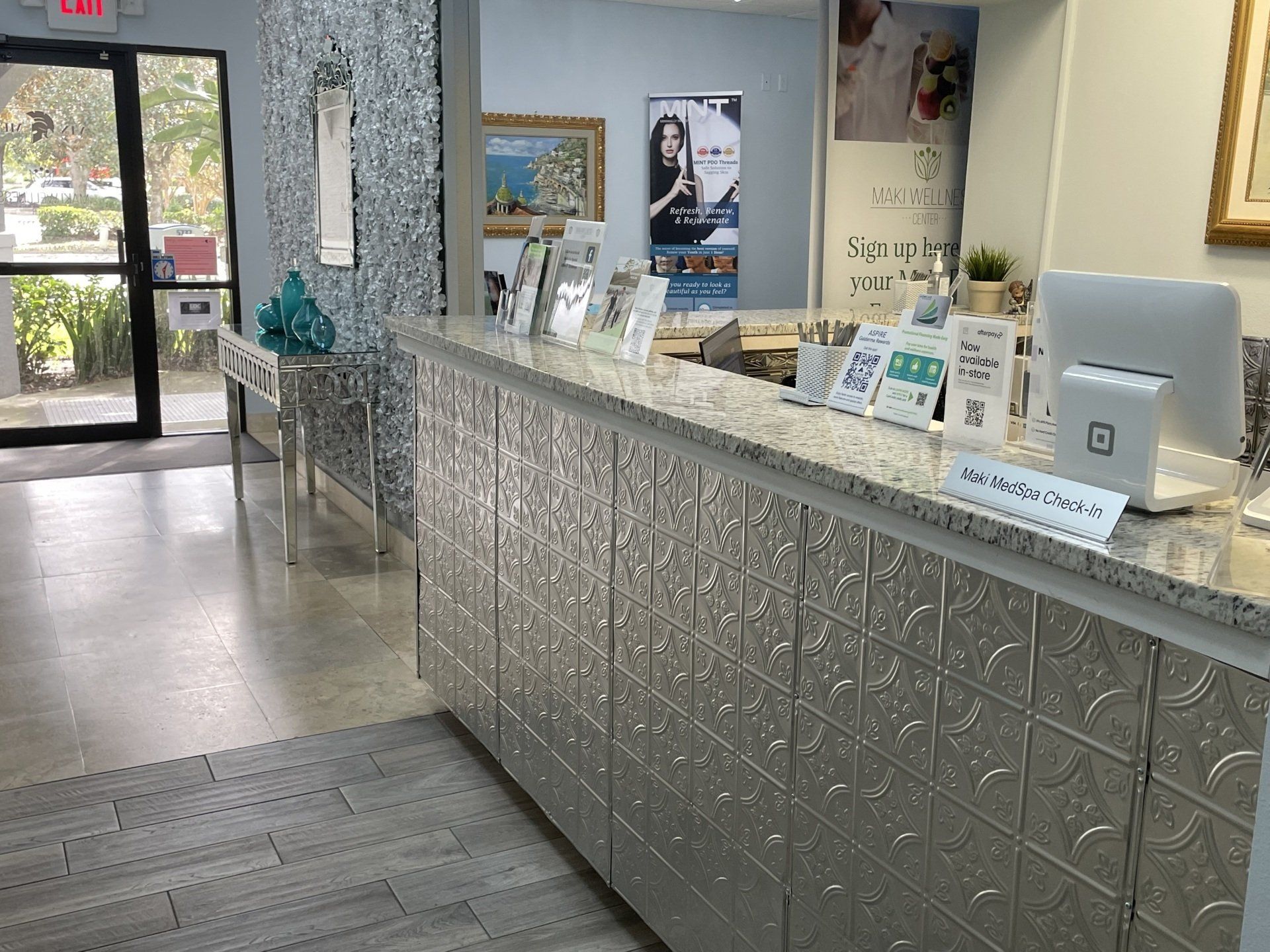 A reception desk in a dental office with a computer on it.