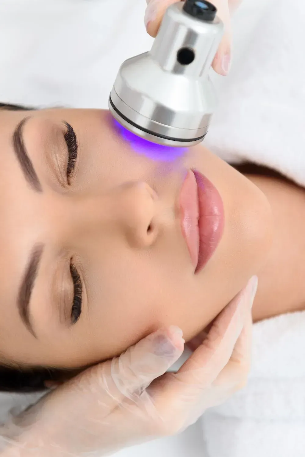 A woman is getting a facial treatment at a beauty salon.