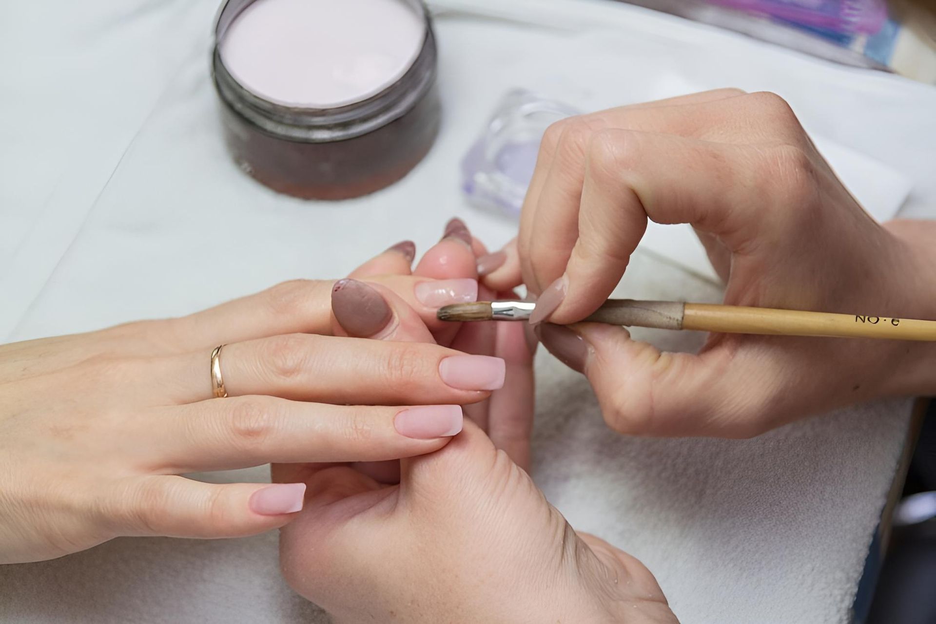 A Woman is Getting Her Nails Painted by a Nail Artist — Nonny Thai Healing Massage In Coffs Harbour, NSW