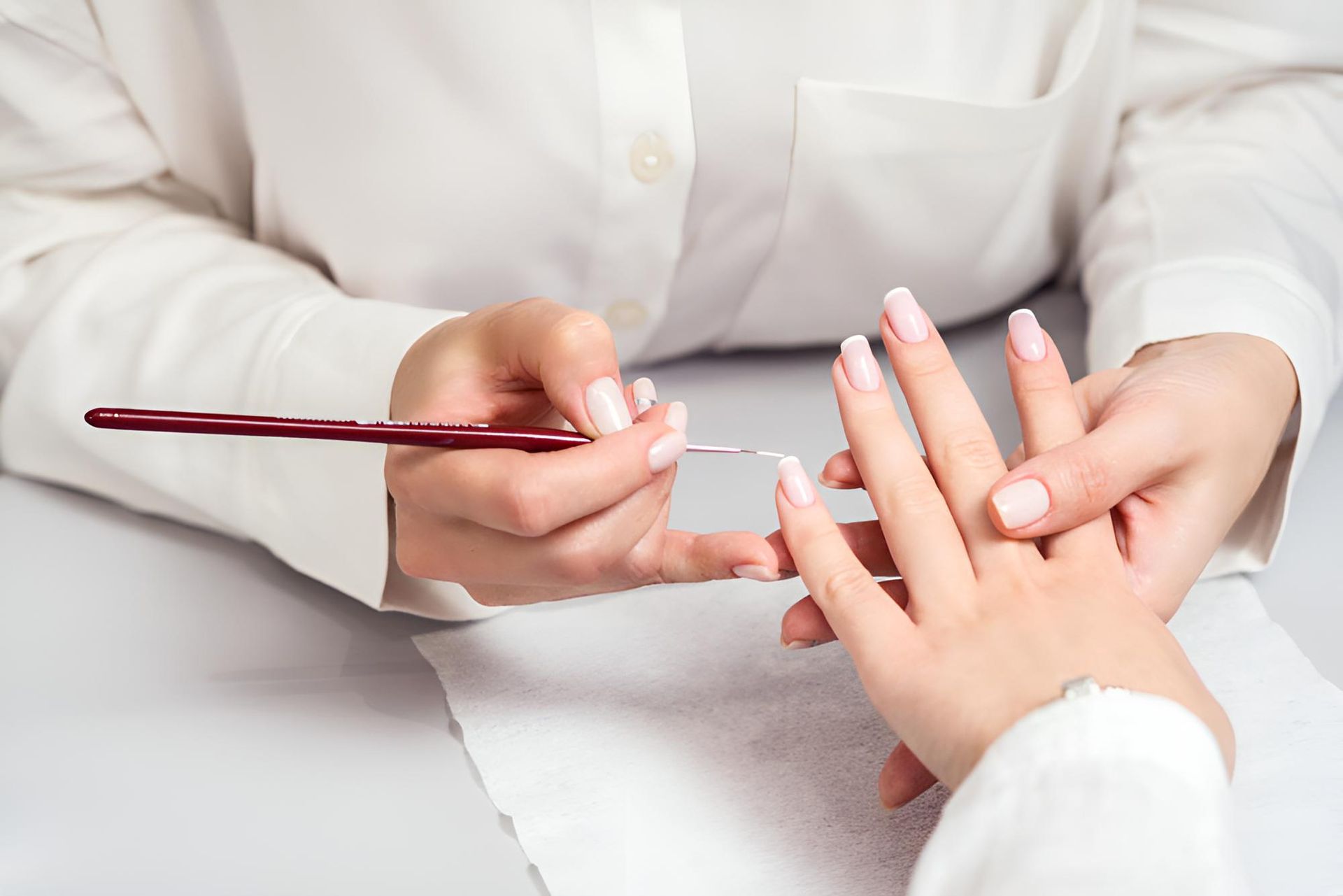A Woman is Getting Her Nails Painted by a Nail Artist — Nonny Thai Healing Massage In Coffs Harbour, NSW