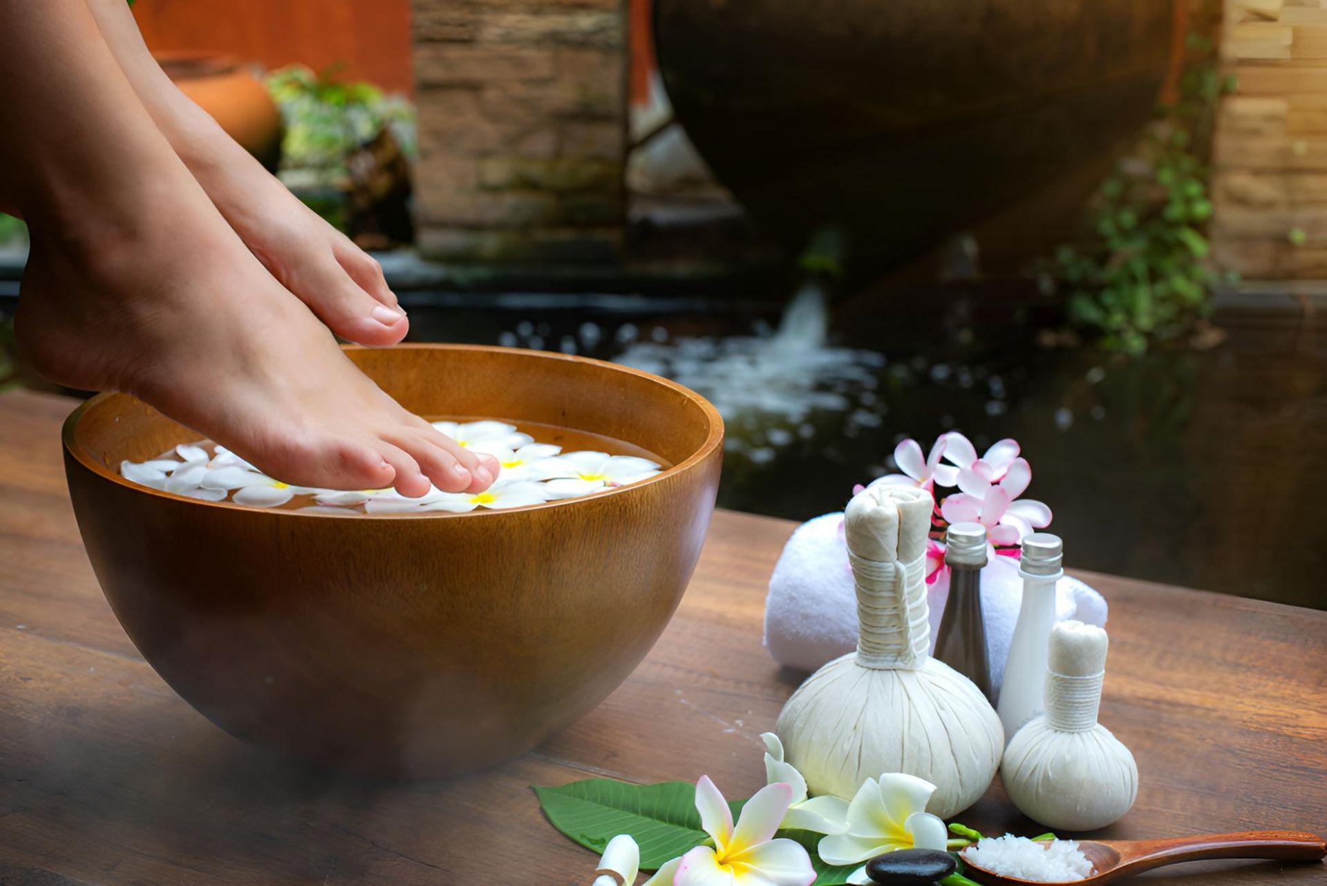 A Woman's Feet Are Being Soaked in a Bowl of Water — Nonny Thai Healing Massage In Coffs Harbour, NSW