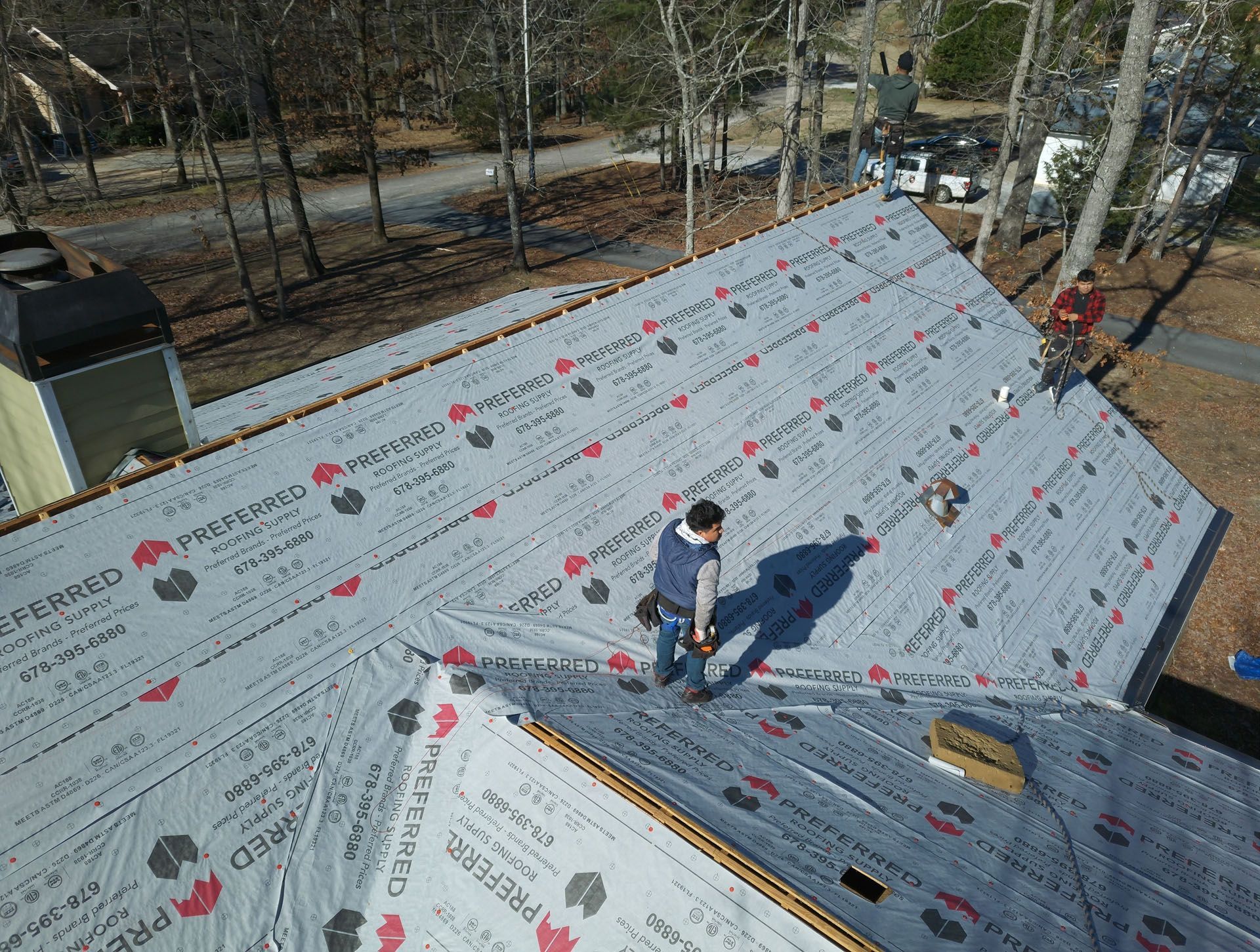 An aerial view of a man working on a roof.