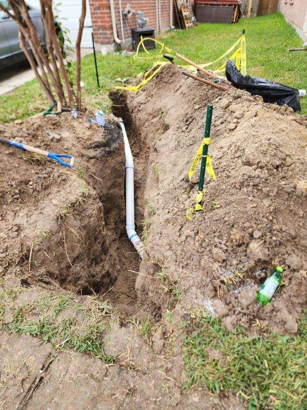 A pipe is being installed in a hole in the ground.
