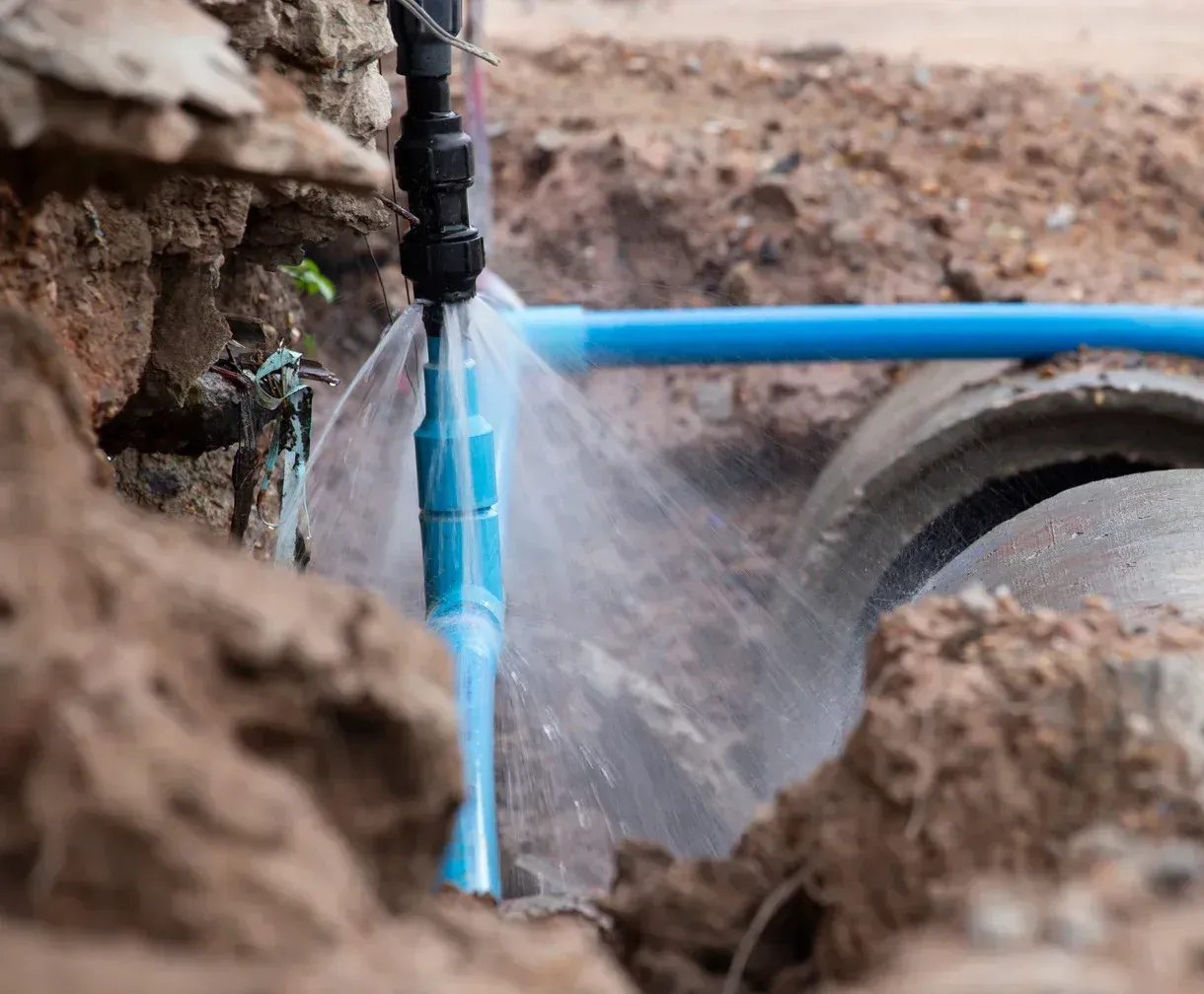 A water pipe is bursting in the dirt.