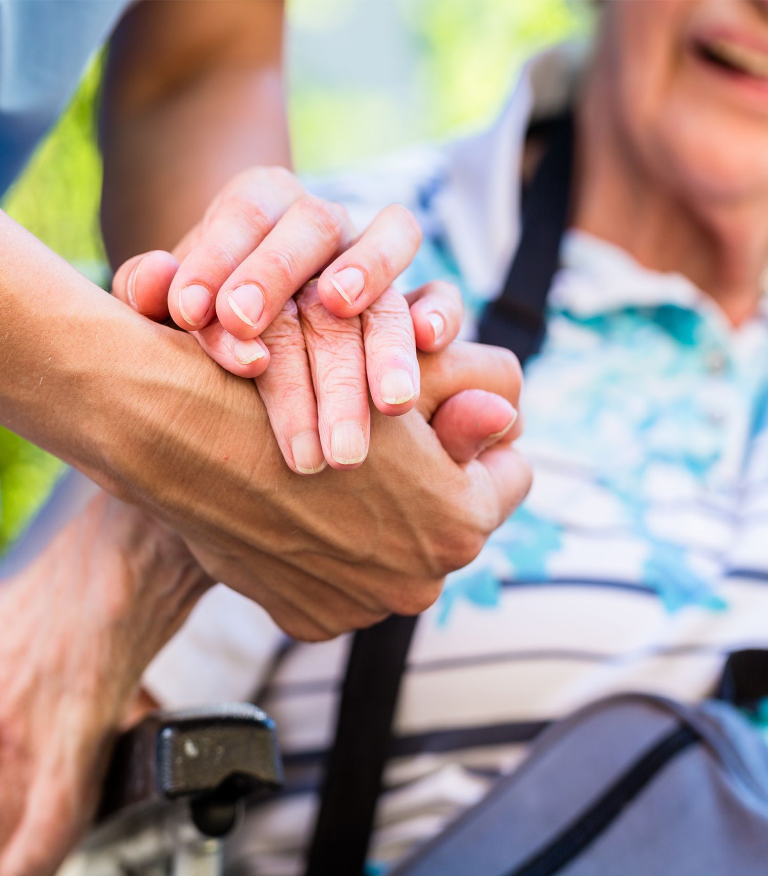Close up image of  a person holding another persons hand in support