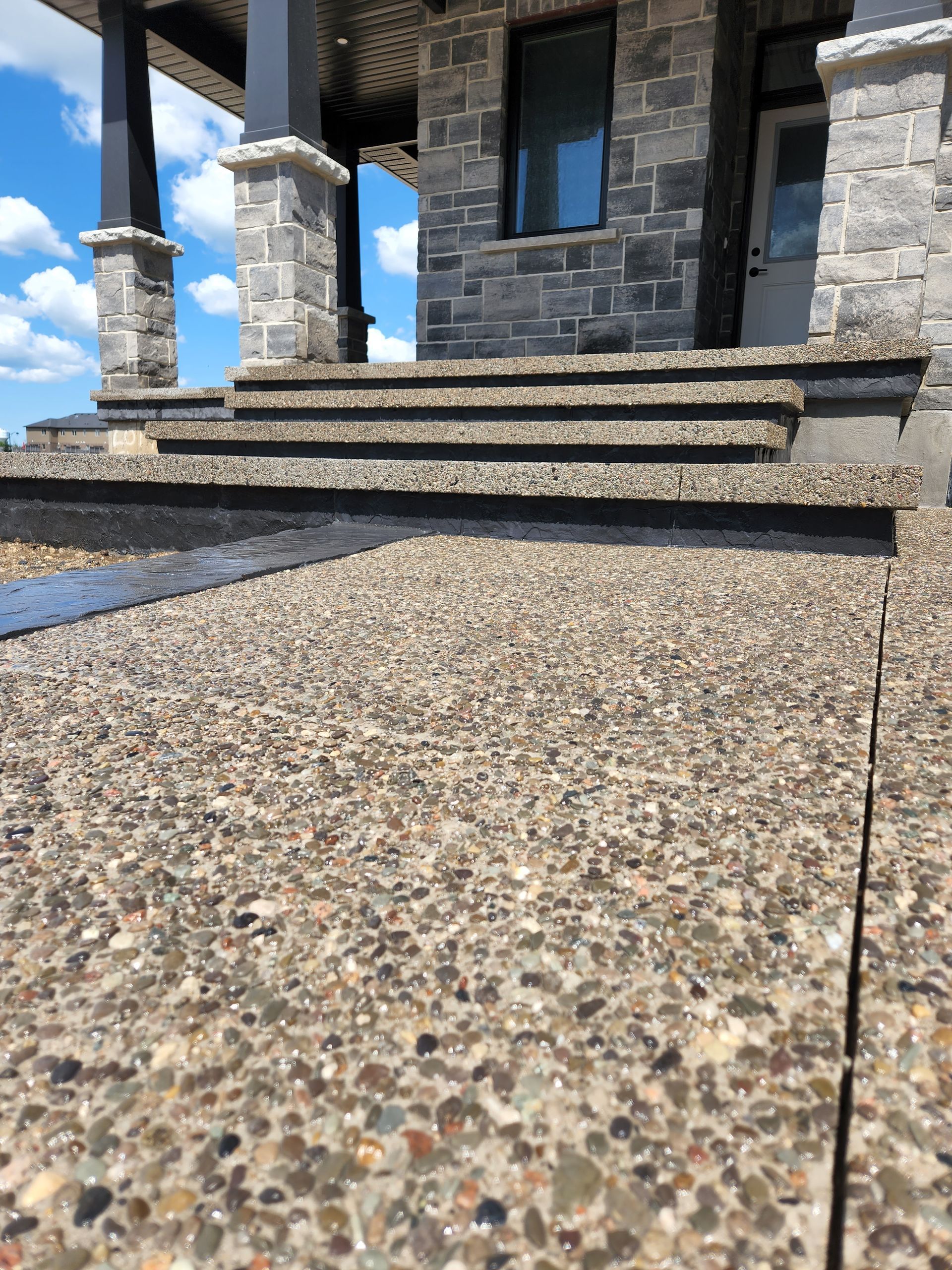 A set of stairs leading up to the front door of a house