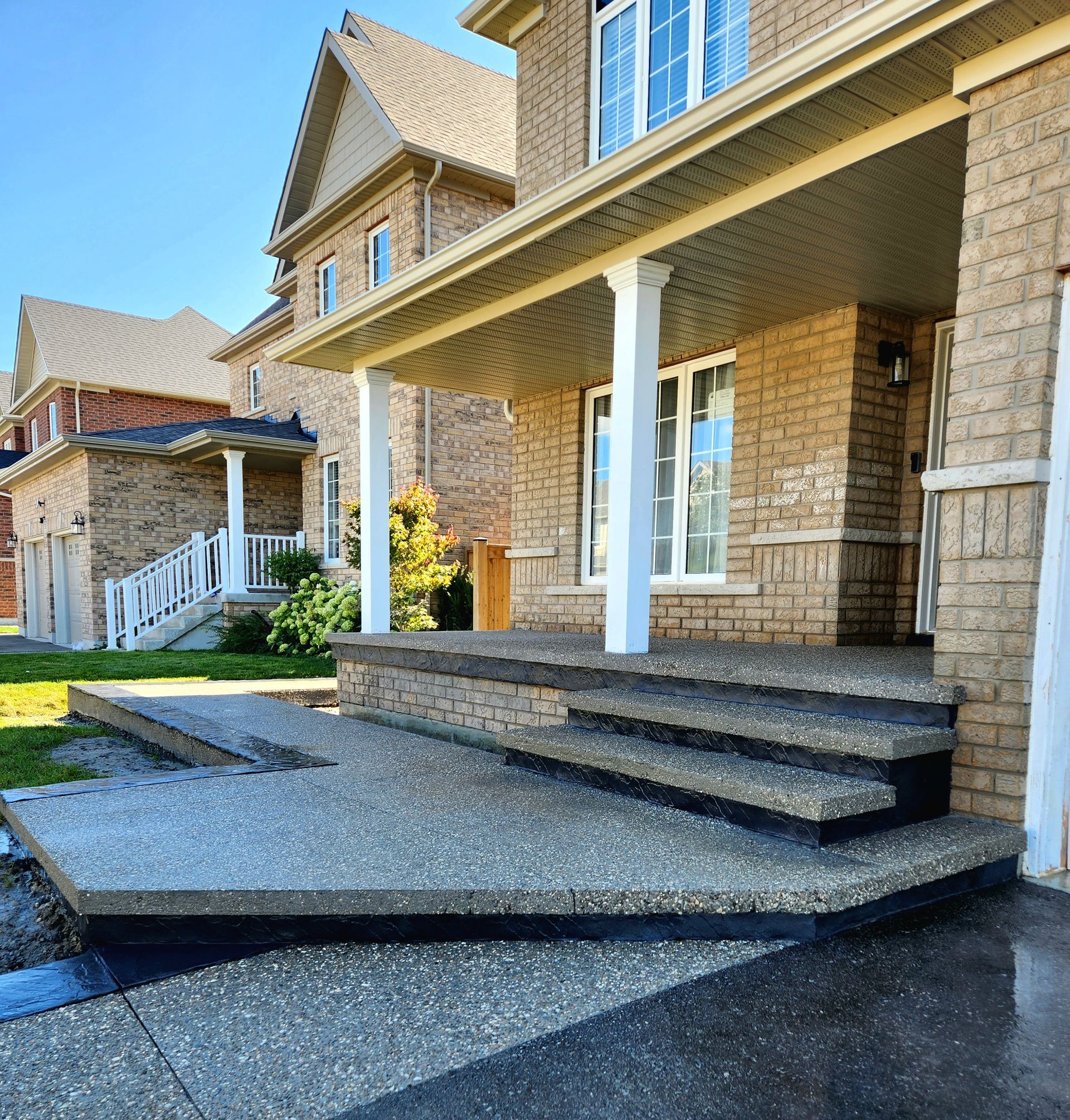 A large brick house with a porch and stairs