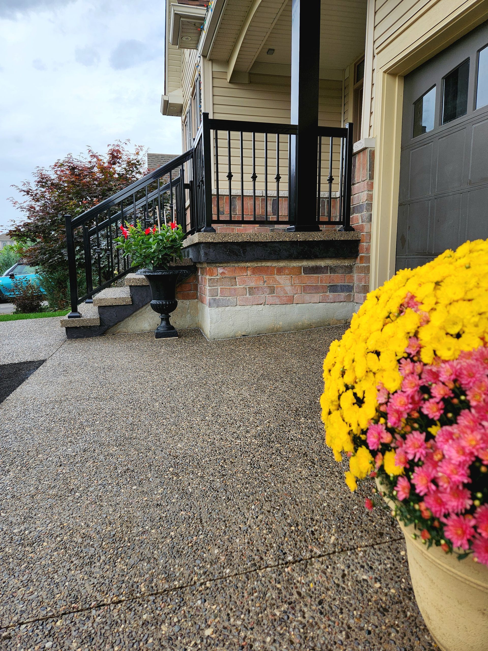 A concrete walkway is being built in front of a house.