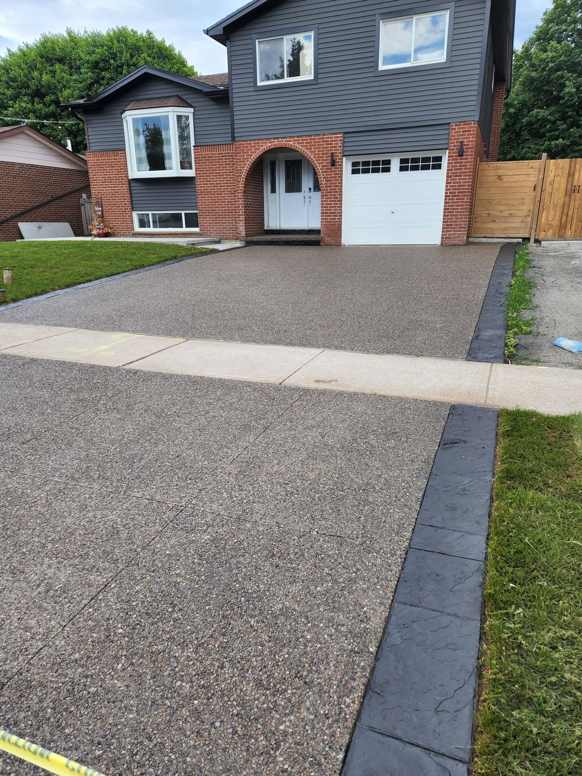 A large brick house with a porch and stairs
