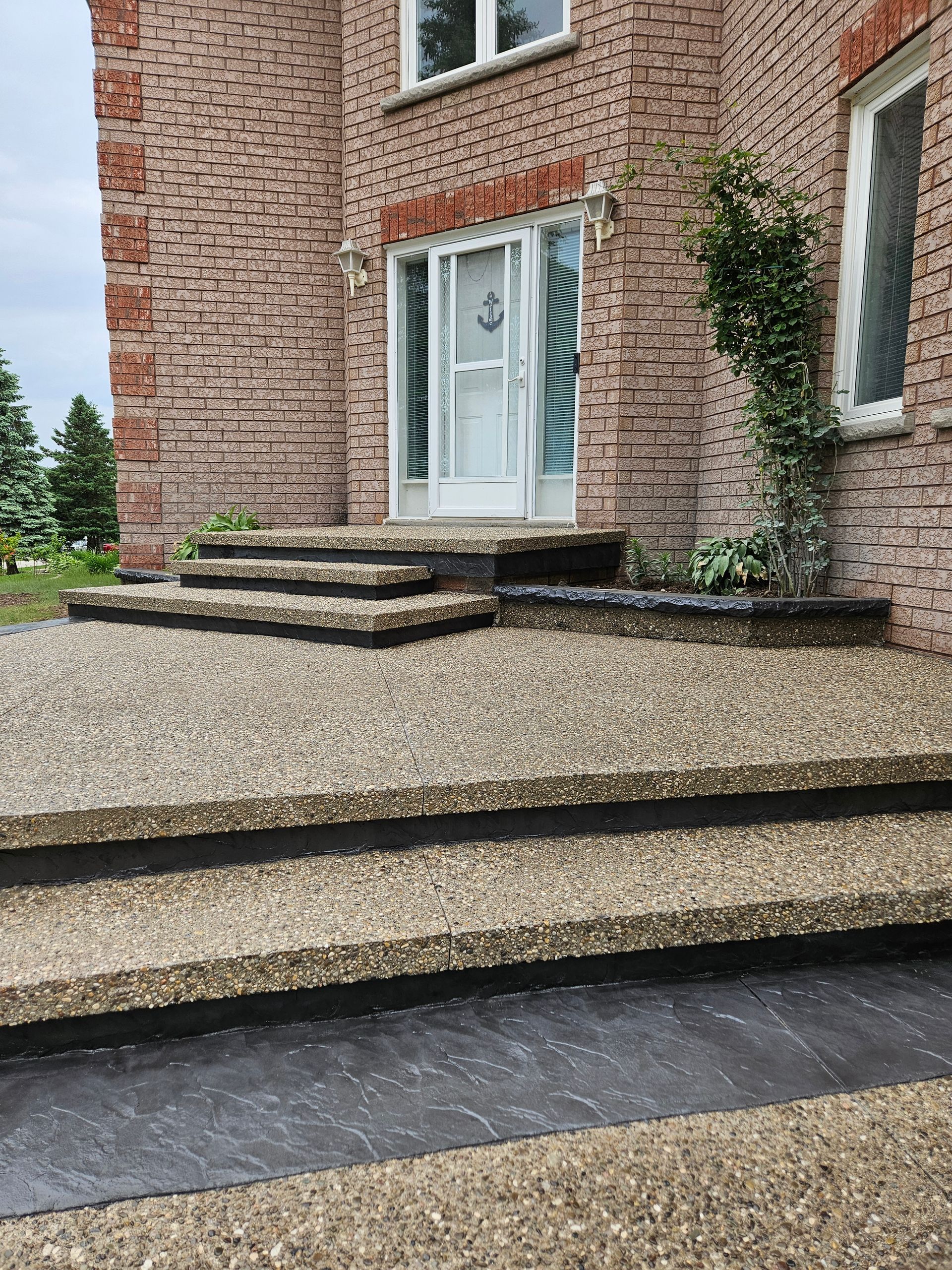 A large house with a concrete driveway in front of it.