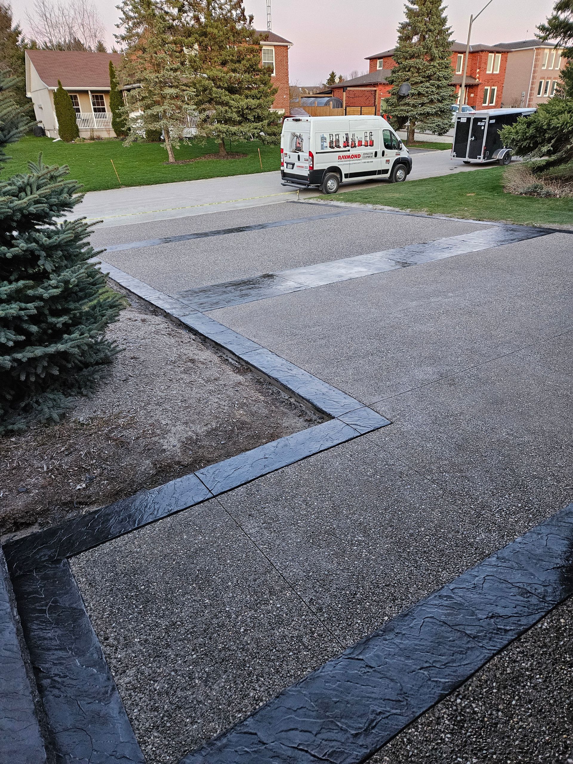 A concrete walkway is being built in front of a house.