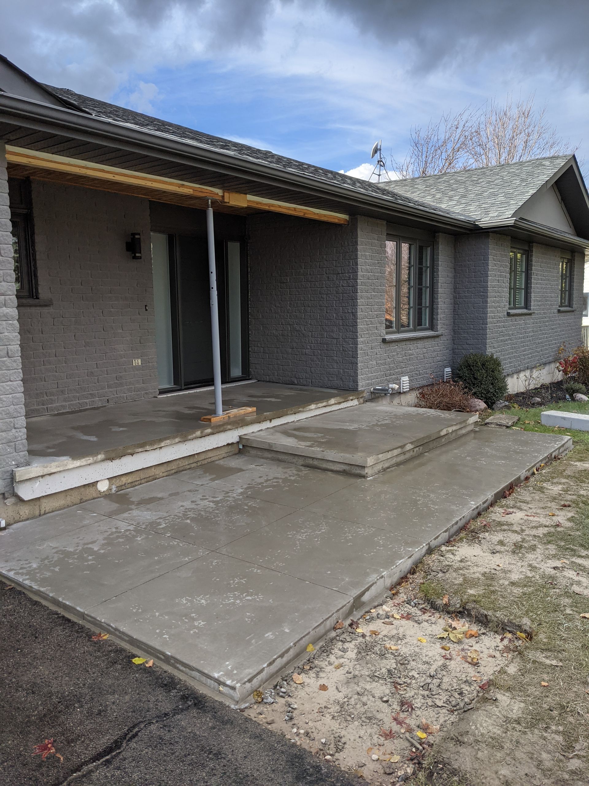 A basement under construction with a concrete floor and wooden walls.