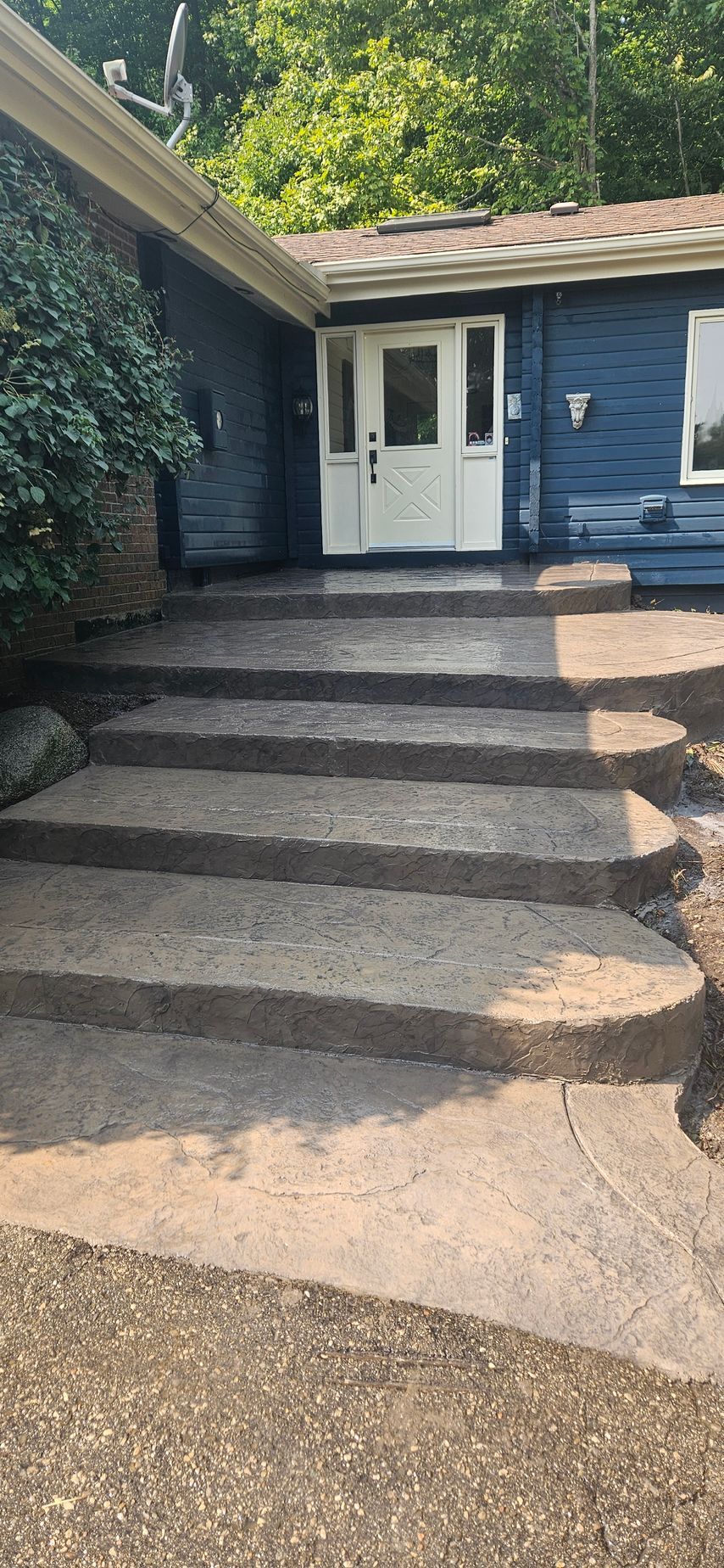 A close up of a gray tile floor with a diagonal line.