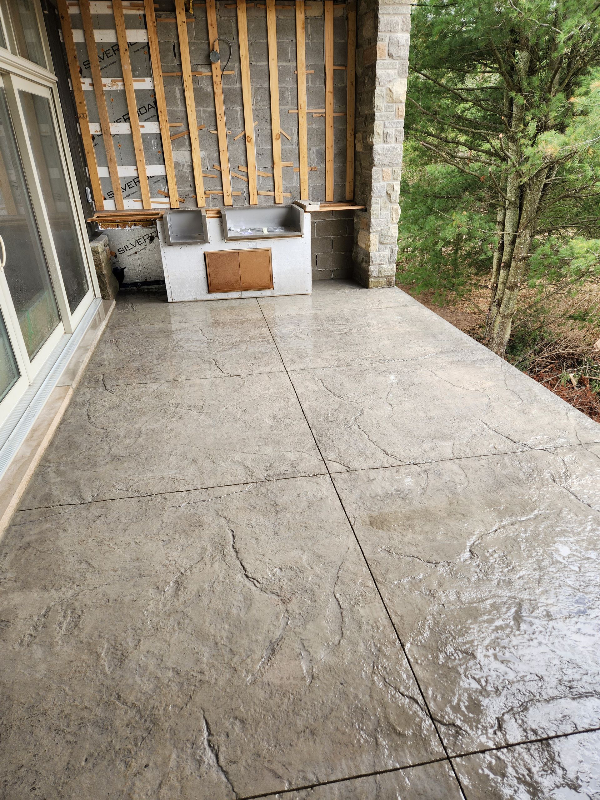 A concrete patio with a sink in the middle of it.