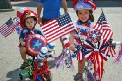 Two Children on Bikes With American Flags
