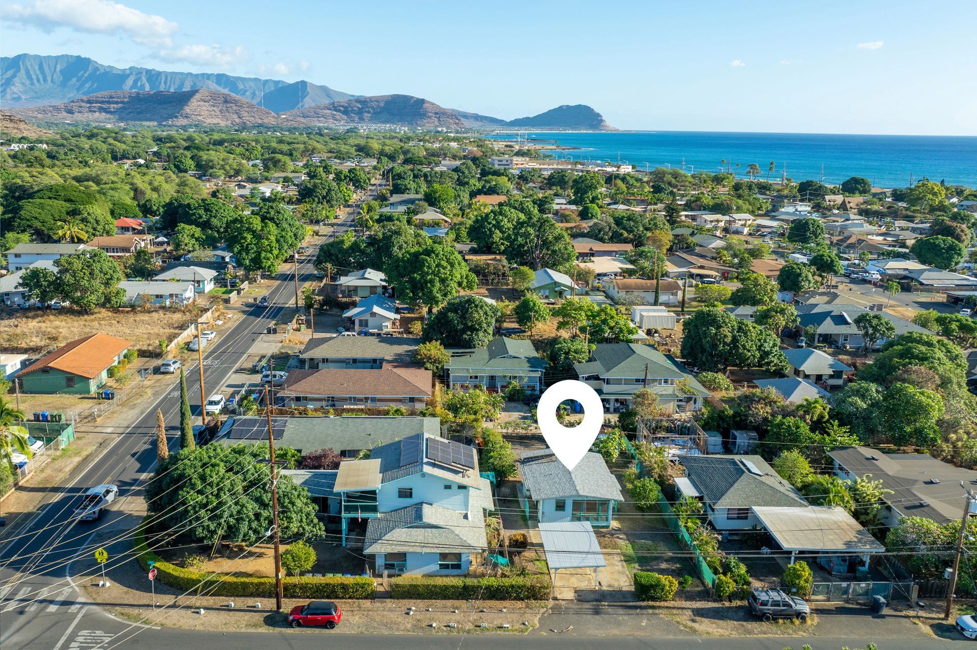 An aerial view of a residential area with a house in the middle.