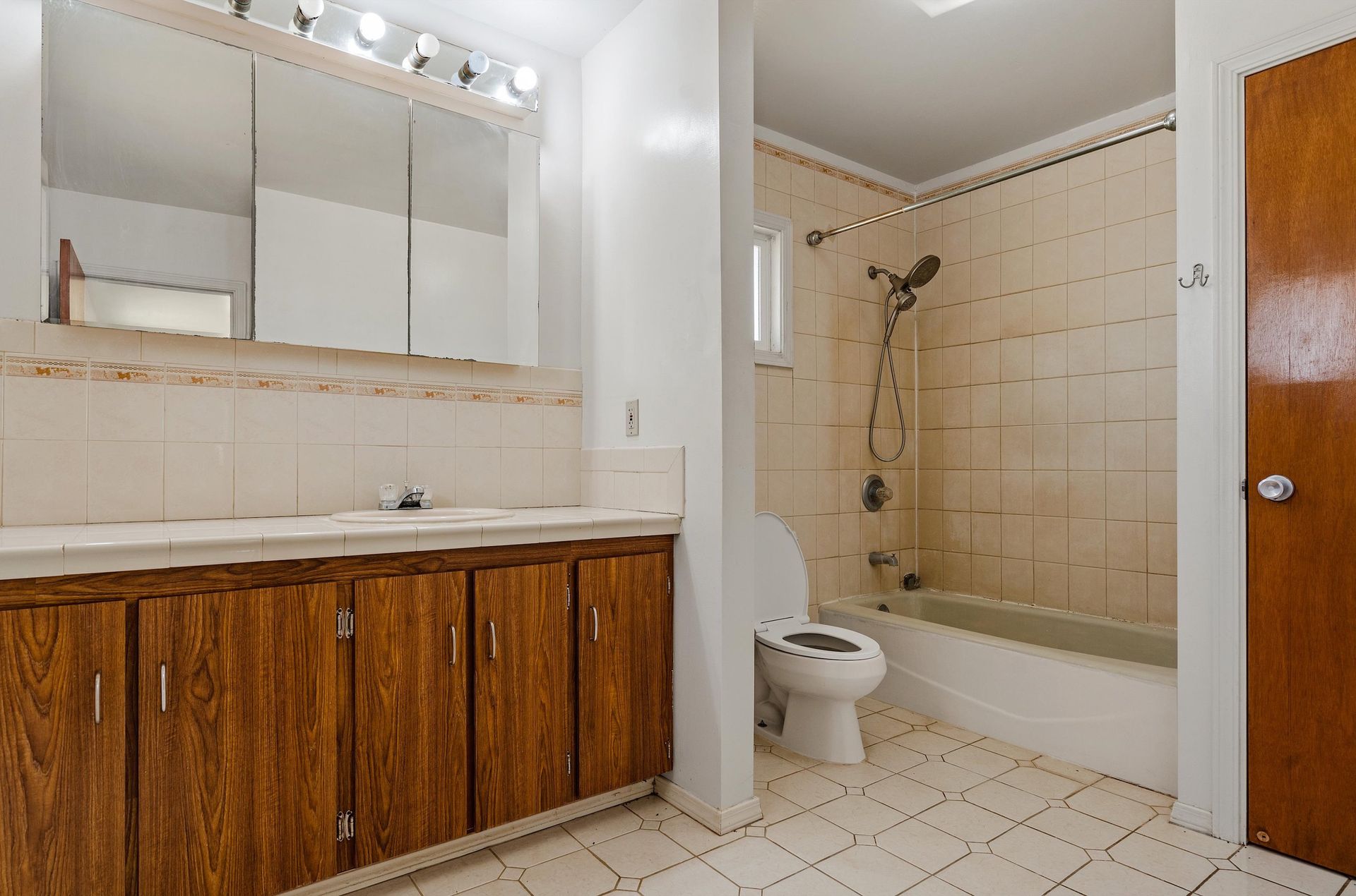 A bathroom with a toilet , sink , and shower.