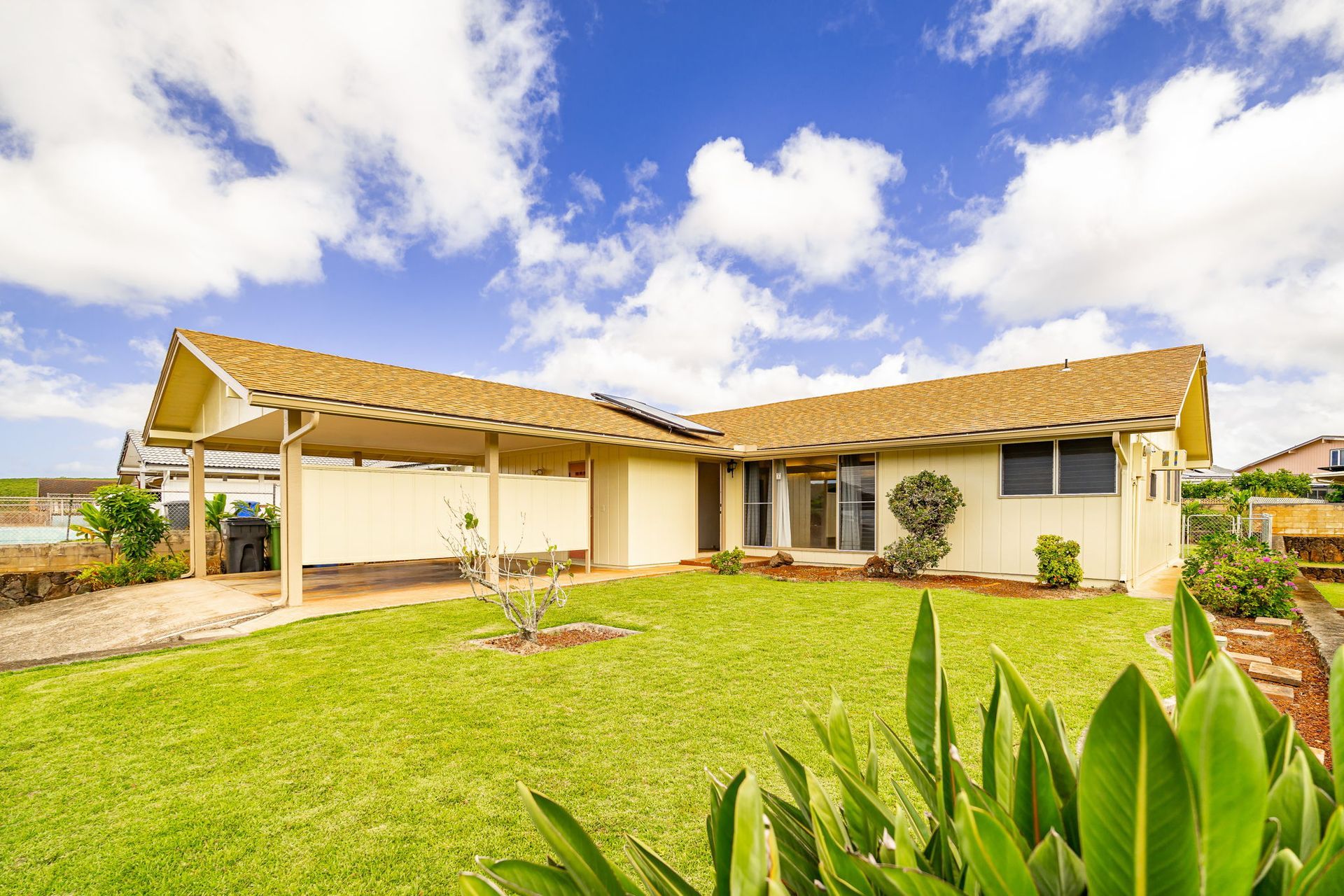 A house with a large lawn in front of it