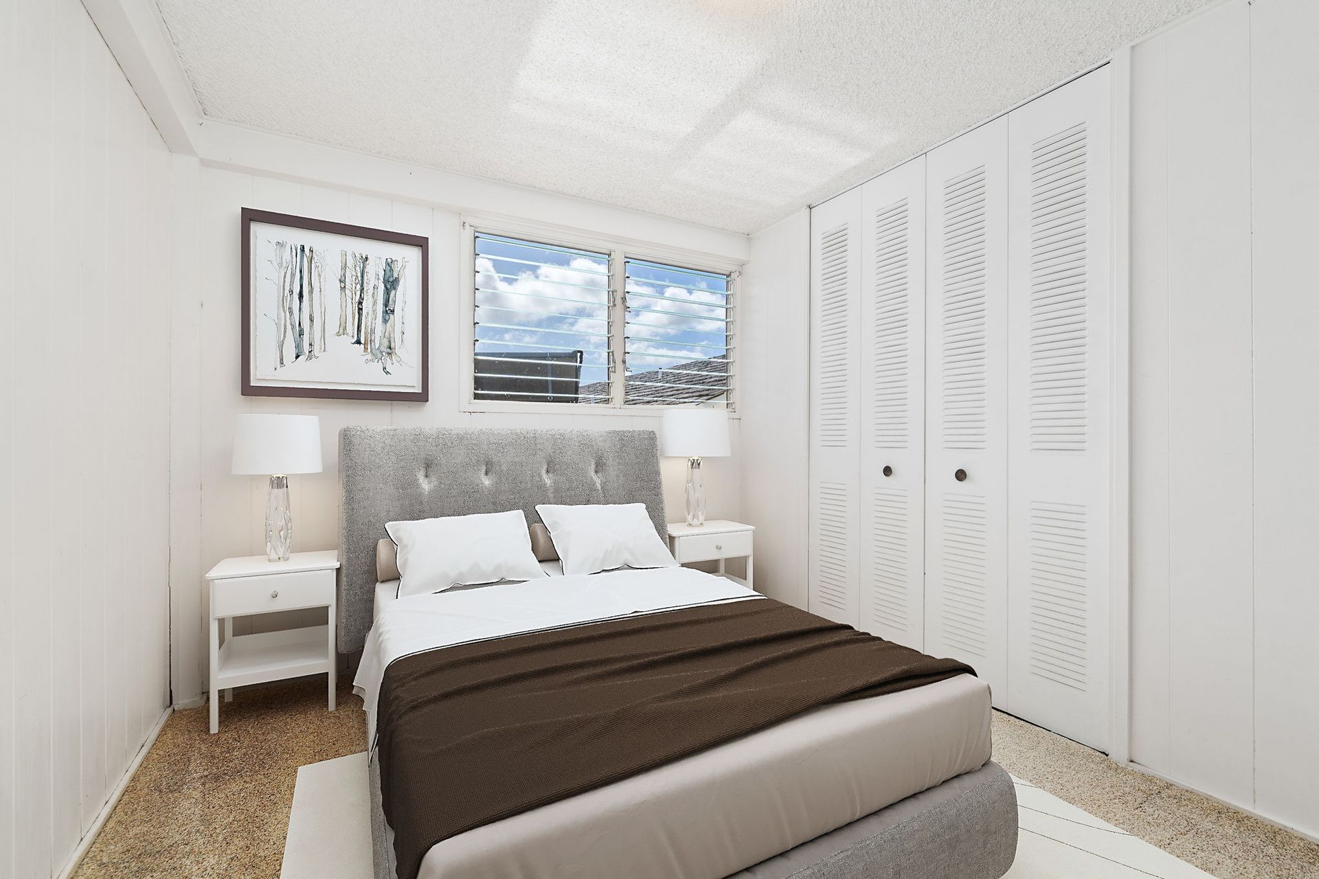 A bedroom with a large bed and two nightstands